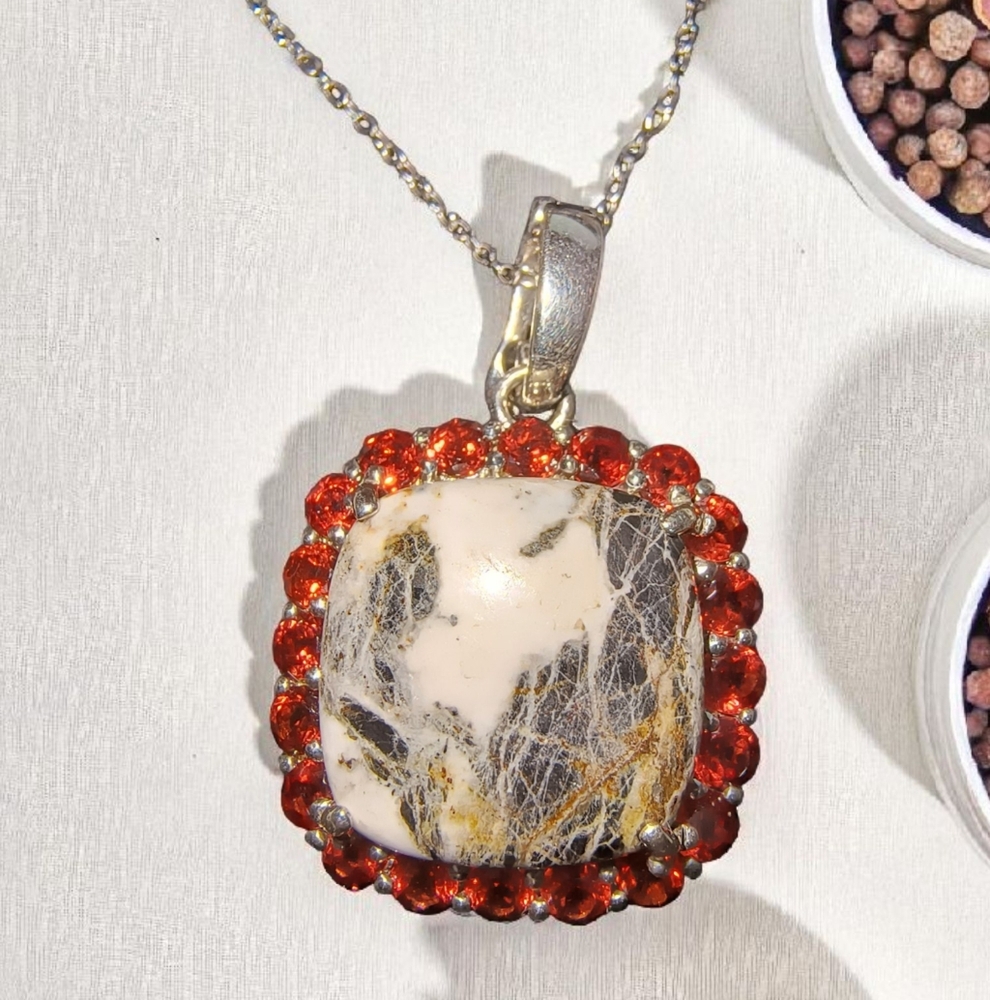 White Buffalo And Mozambique Garnet Halo Necklace In Sterling Silver